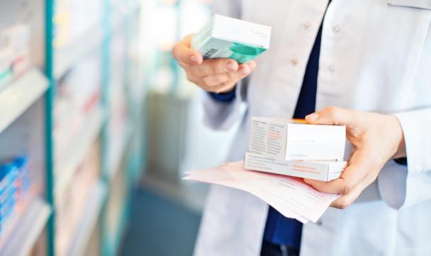 pharmacist holding medication in her hand